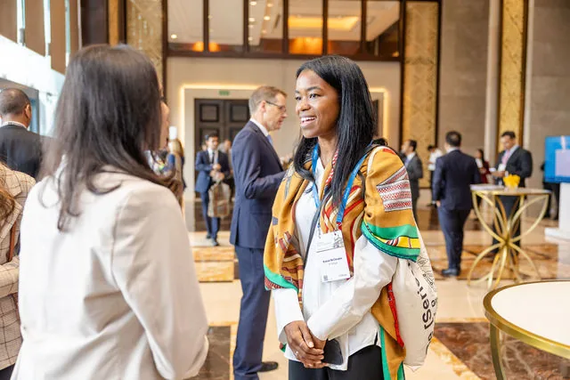 Conference attendees in conversation at a J.P. Morgan event