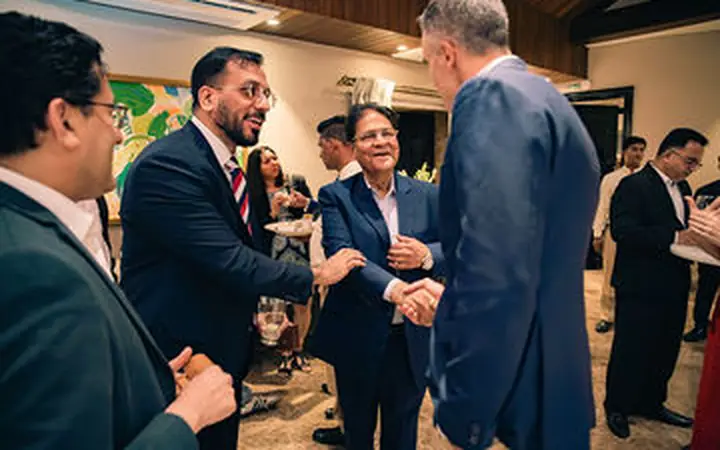 Senior delegates networking during a convention programme