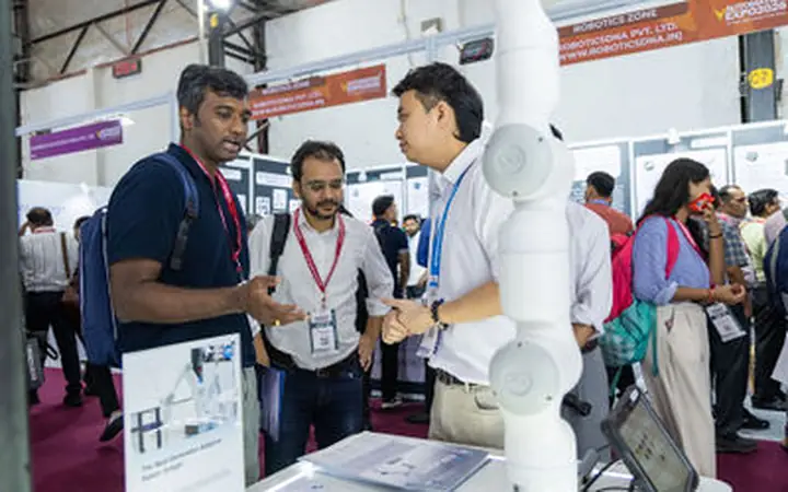 Trade Show Photographer Mumbai Mumbai Photography Buyer conversation beside a branded exhibition booth